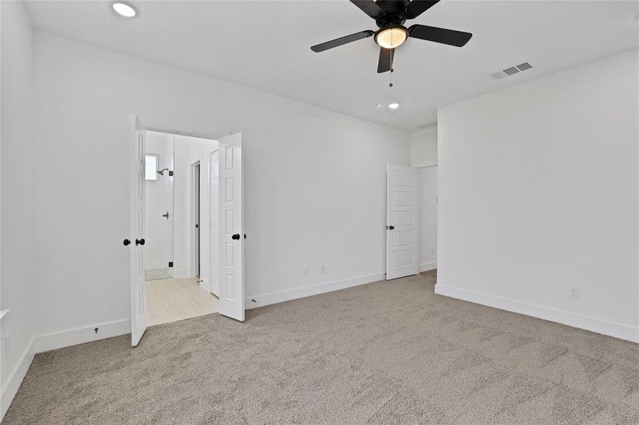 Primary bedroom room with ceiling fan.