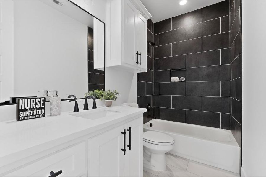 Full bathroom featuring vanity and shower / washtub combination Full bathroom featuring vanity and shower / washtub combination