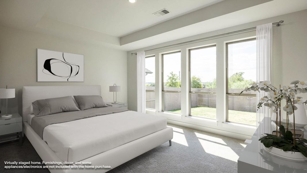 Carpeted bedroom featuring a raised ceiling and recessed lighting Carpeted bedroom featuring a raised ceiling and recessed lighting