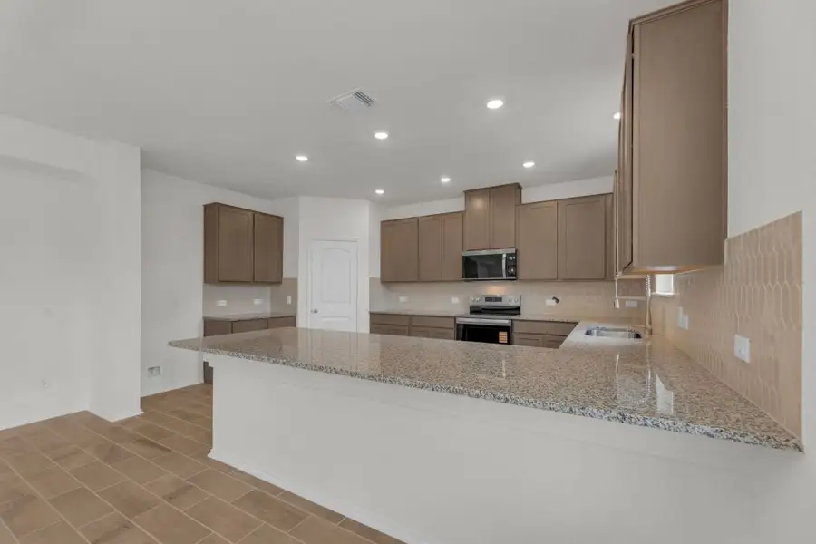 Furnished interior view inside a new home in Mustang Valley, Manor (Image 6).