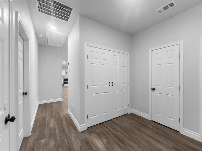 Unfurnished bedroom featuring dark hardwood / wood-style flooring