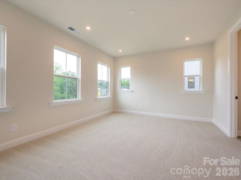 Primary Suite Surrounded By Bright Windows.