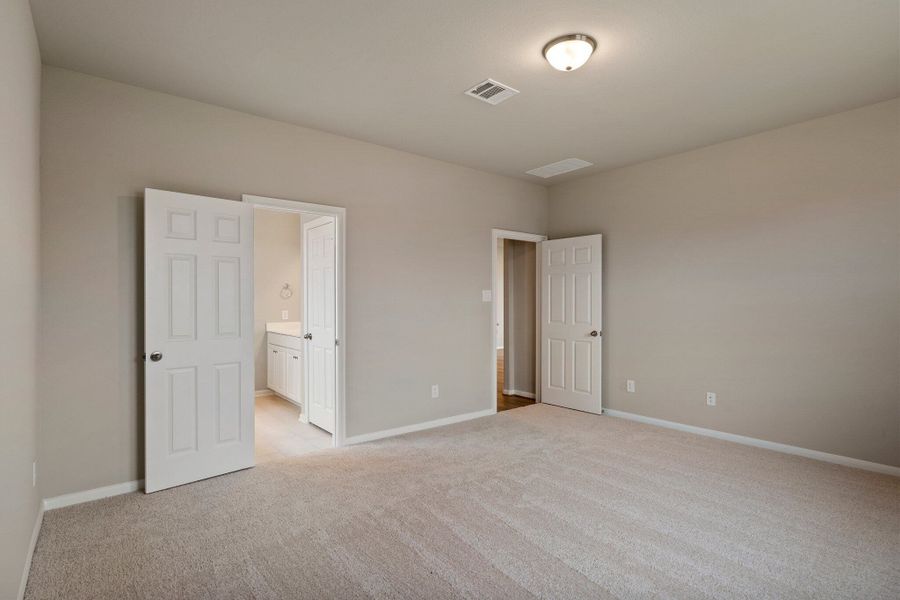 An additional view of the primary bedroom and en-suite.