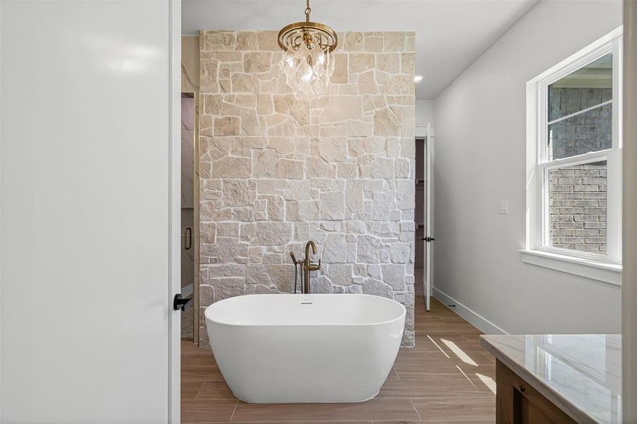 Full bathroom featuring a freestanding bath, wood finish floors, a chandelier, vanity, and recessed lighting Full bathroom featuring a freestanding bath, wood finish floors, a chandelier, vanity, and recessed lighting