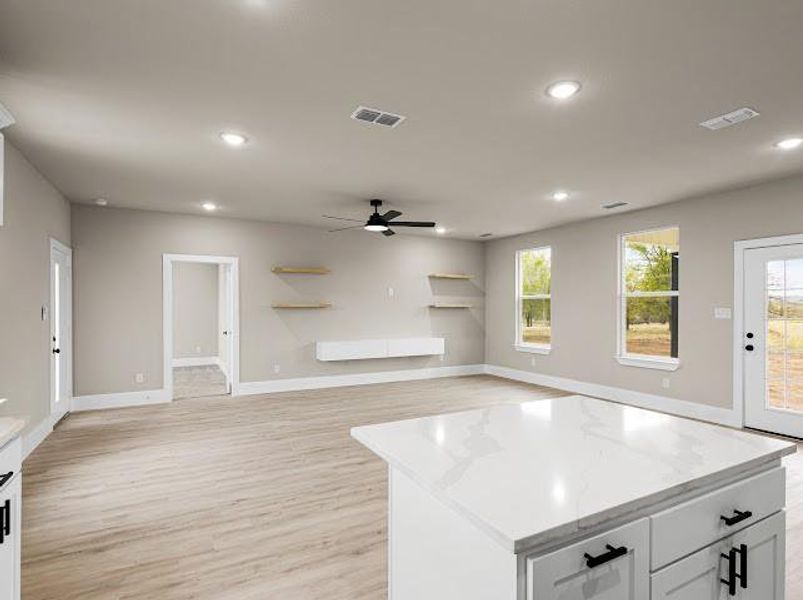 Kitchen with white cabinets, light wood-style floors, recessed lighting, open floor plan, and ceiling fan