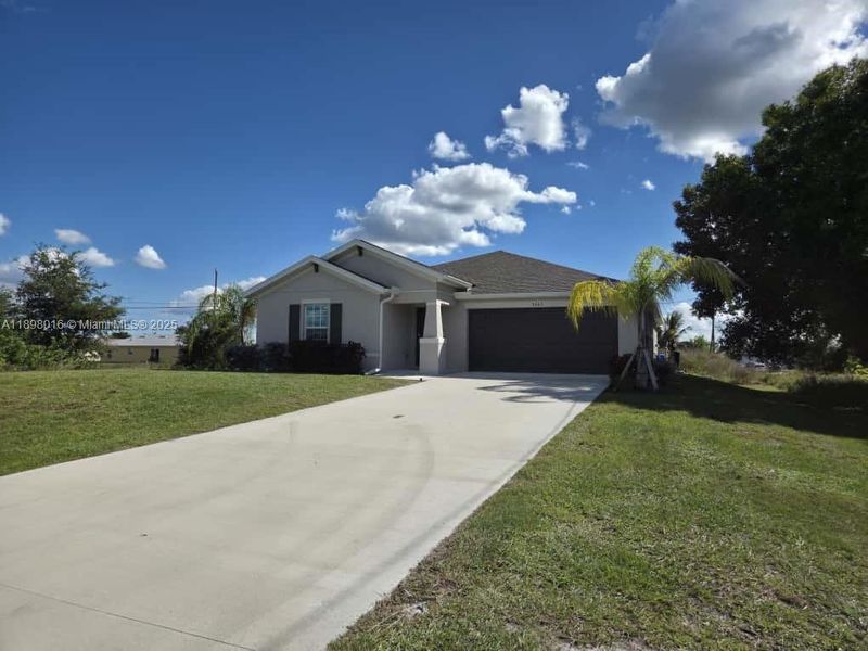 Front exterior of a new home in , Lehigh Acres, FL, highlighting curb appeal (Image 1). Front exterior of a new home in , Lehigh Acres, FL, highlighting curb appeal (Image 1).