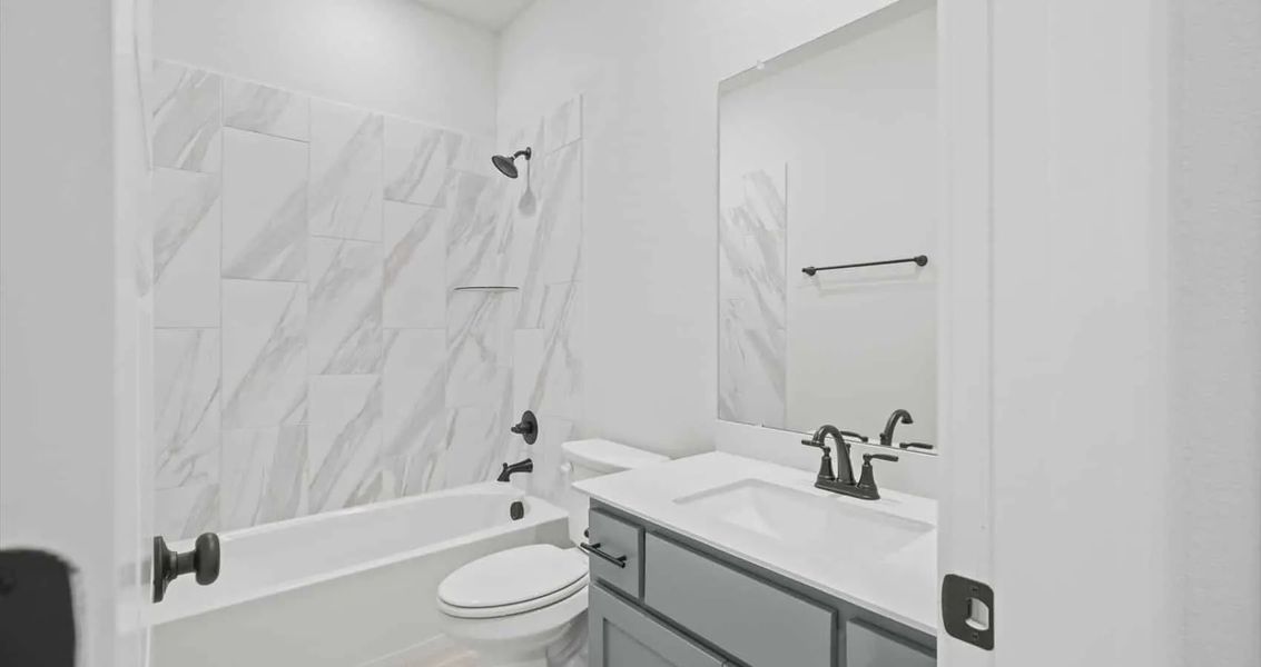 Representative furnished interior of a home built from the Avril by Chesmar Homes in Trace, New Caney (Image 7).