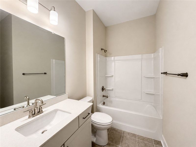 Modern fixtures and durable tile flooring define t