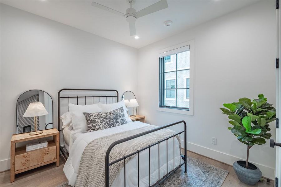 Bedroom featuring hardwood / wood-style floors and ceiling fan