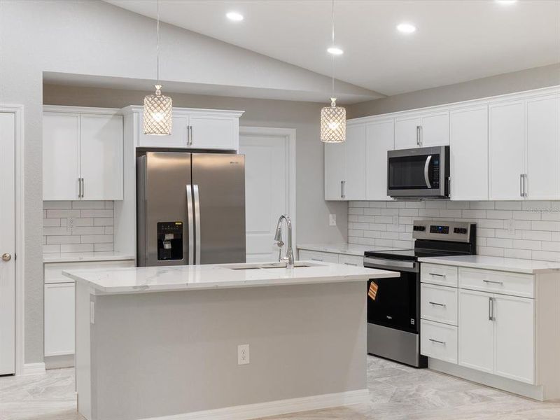 Solid wood, quartz countertops, tile backsplash, & stainless steel appliances.