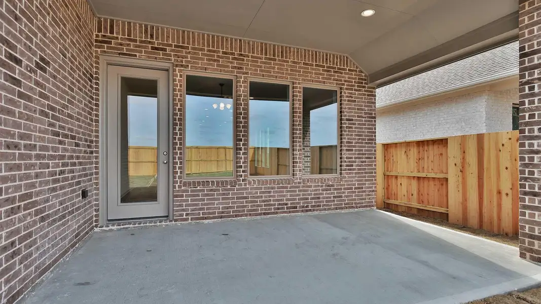 Exterior details and patio area of a home in Meridiana, Manvel (Image 3).