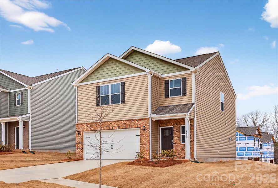 Front exterior of a new home in Reedy Creek Preserve, Charlotte, NC, highlighting curb appeal (Image 2).