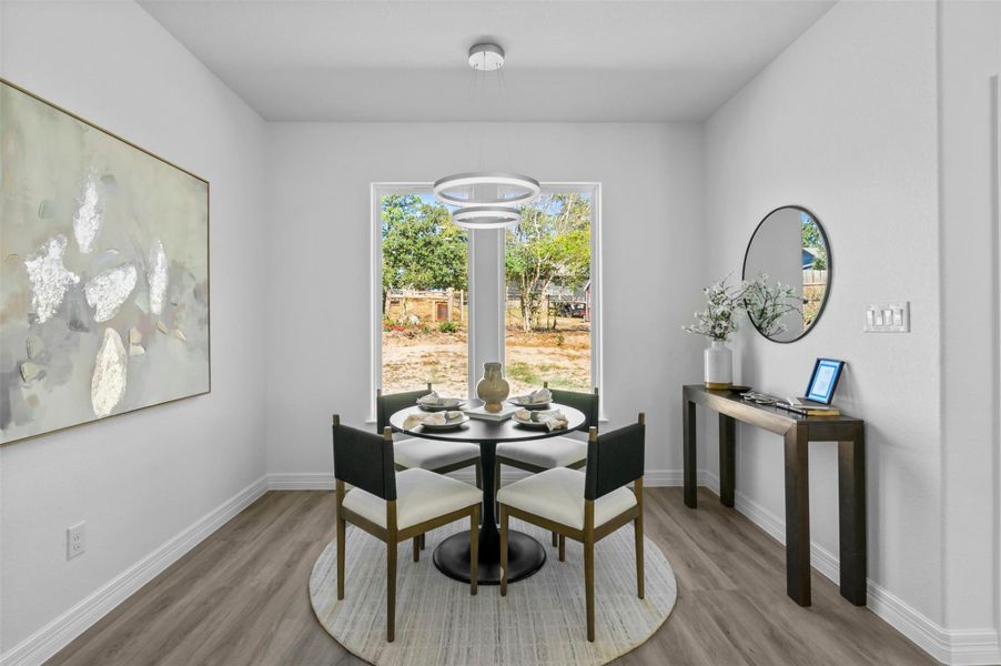 Dining space with baseboards and light wood-style floors