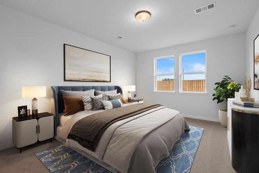 The primary bedroom is generously sized, creating a tranquil and spacious retreat that offers ample room for relaxation. Featuring plush carpet, high ceilings, fresh paint, and large windows that lets in natural lighting throughout the day.