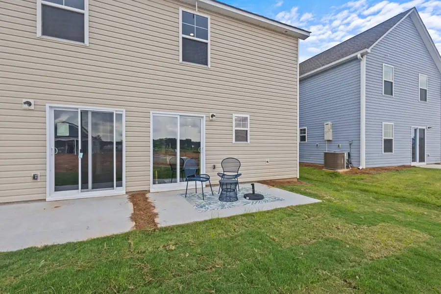 Exterior details and patio area of a home in Champions Village at Cherry Hill, Pendleton (Image 3).