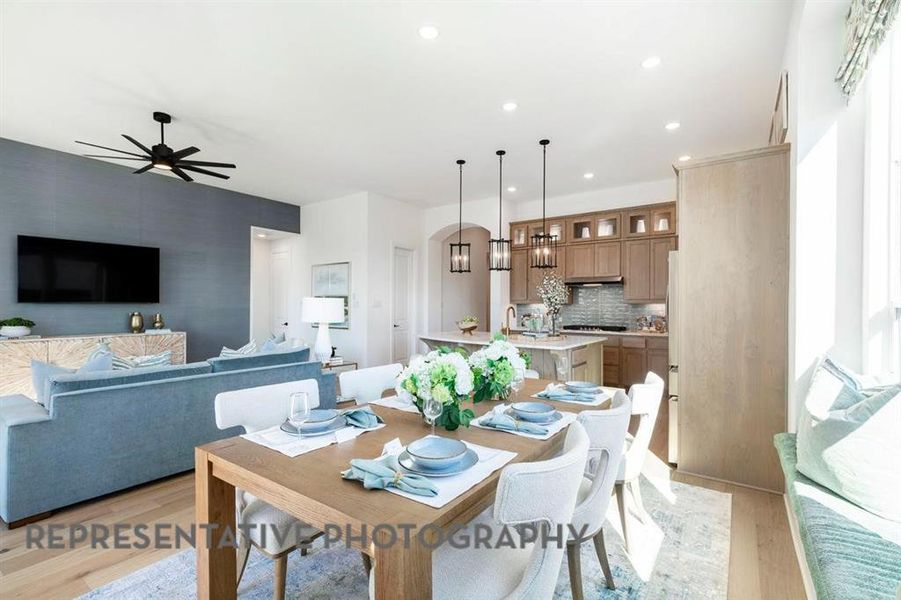 Dining area with light wood-style floors, ceiling fan, and recessed lighting