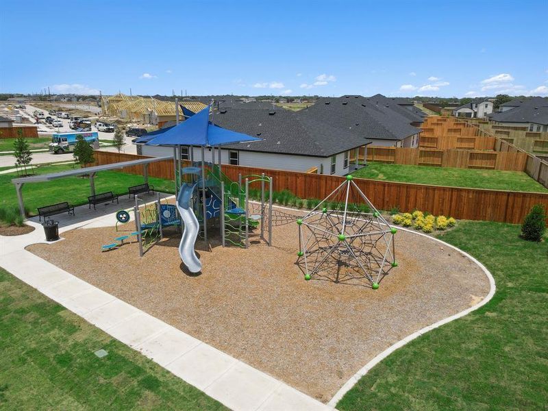 A well-appointed playground invites children to play and explore, while open grassy areas provide ample space for sports, gatherings, and family activities. Shaded seating areas and nearby trails make it easy to relax or connect with neighbors.