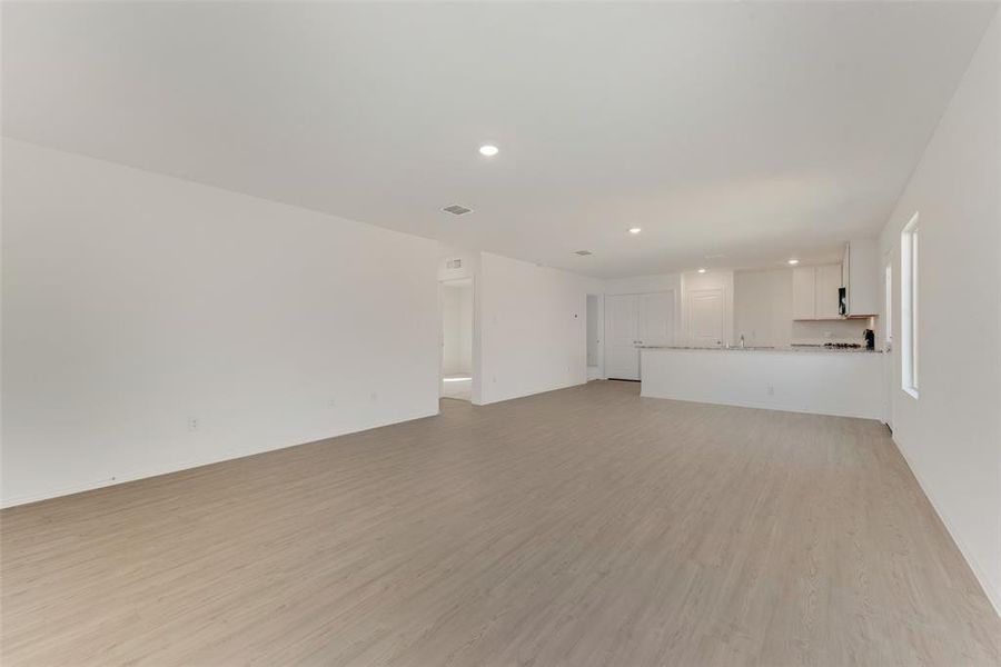 Unfurnished living room featuring light wood-type flooring