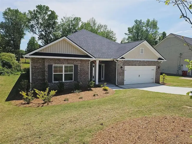 Front exterior of a new home in Scarlett Place, Bowdon, GA, highlighting curb appeal (Image 2). Front exterior of a new home in Scarlett Place, Bowdon, GA, highlighting curb appeal (Image 2).