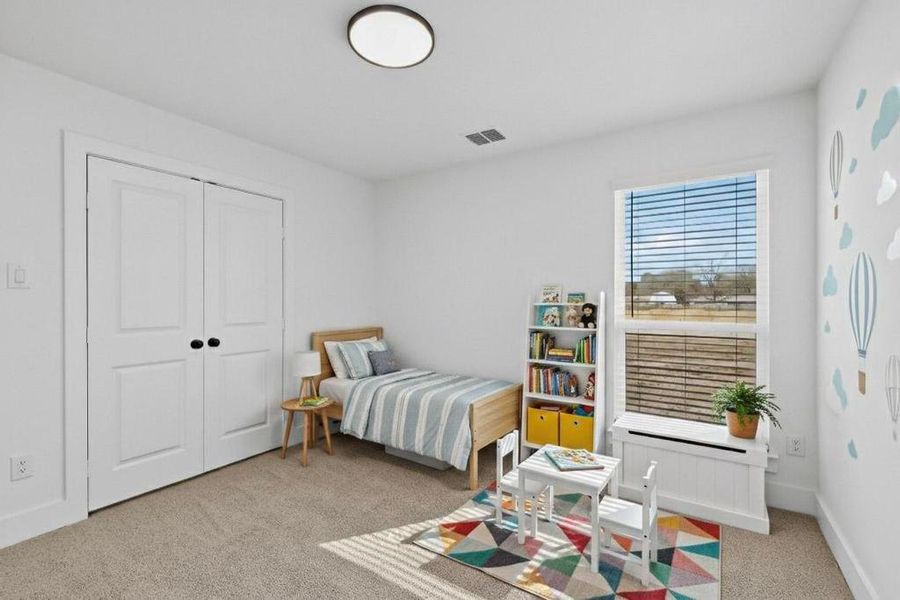 Bedroom featuring light carpet and a closet