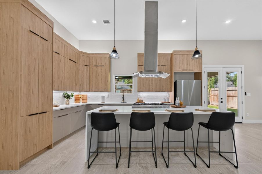 Stunning modern kitchen with sleek wood cabinetry, a spacious island with seating for four, and high-end stainless steel appliances, all illuminated by stylish pendant lighting.