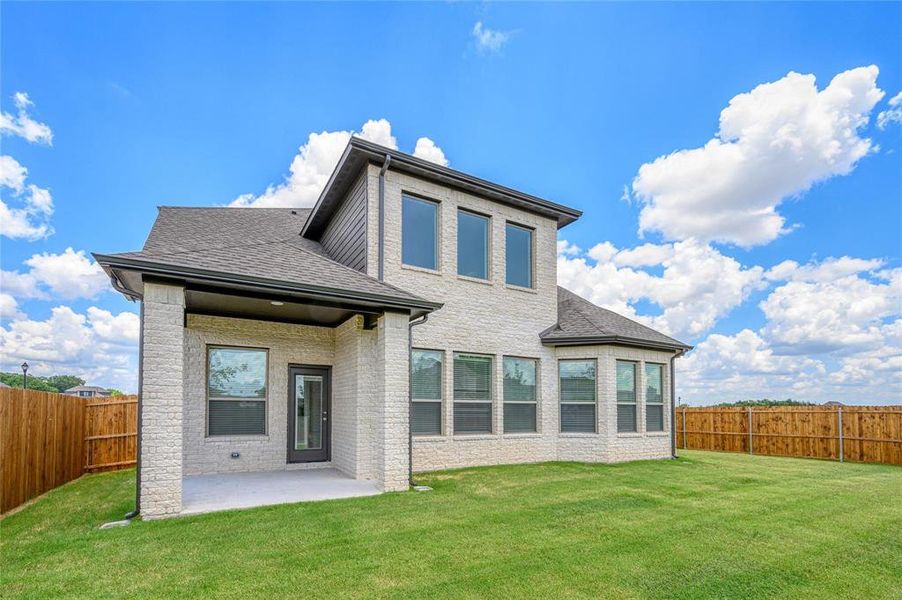 Back of house featuring a yard and a patio