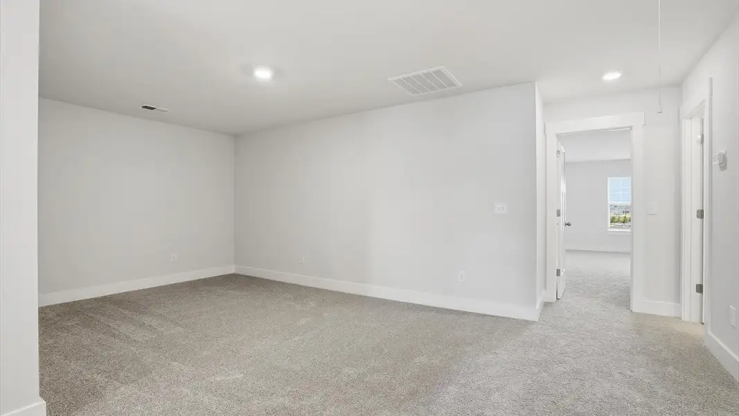 Stylish loft retreat with carpeted flooring and accomplished architectural detail by DRB Homes