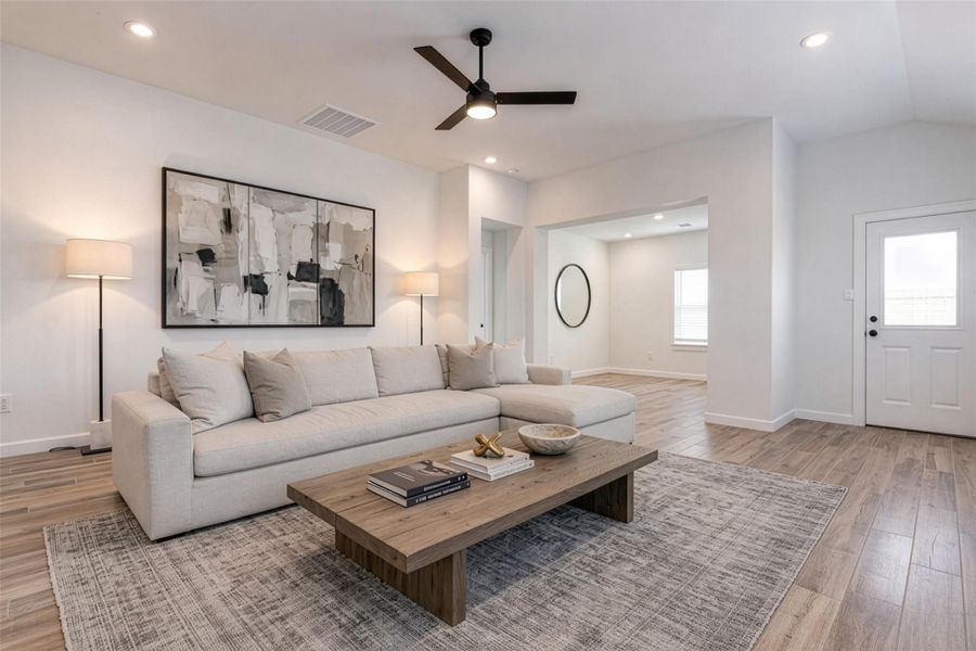 Enjoy the spaciousness of this open living area, designed for both comfort and versatility. High ceilings and recessed lighting enhance the airy feel, while the seamless connection to the kitchen creates an ideal environment for entertaining. The neutral finishes and wide layout provide endless possibilities for furniture arrangement and personalization. This photo is virtually staged.