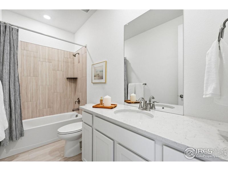 Main-level FULL bathroom with modern finishes and a clean, timeless design.