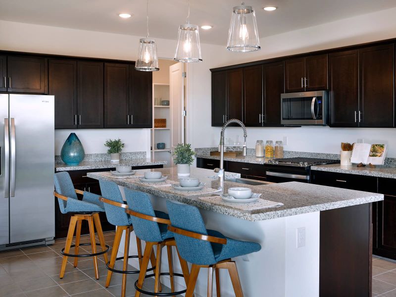 Free flowing kitchen featuring brown cabinets and white granite counter tops