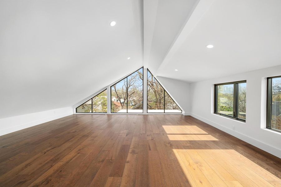 Unfurnished living room with recessed lighting, vaulted ceiling with beams, baseboards, and hardwood / wood-style floors