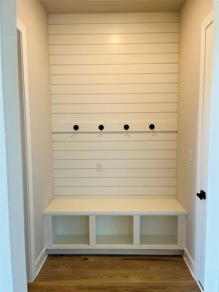 Mudroom and laundry room are conveniently adjacent as you enter from the garage.