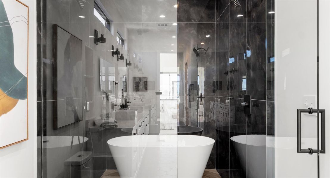 Bathroom featuring a stall shower, a freestanding bath, and vanity