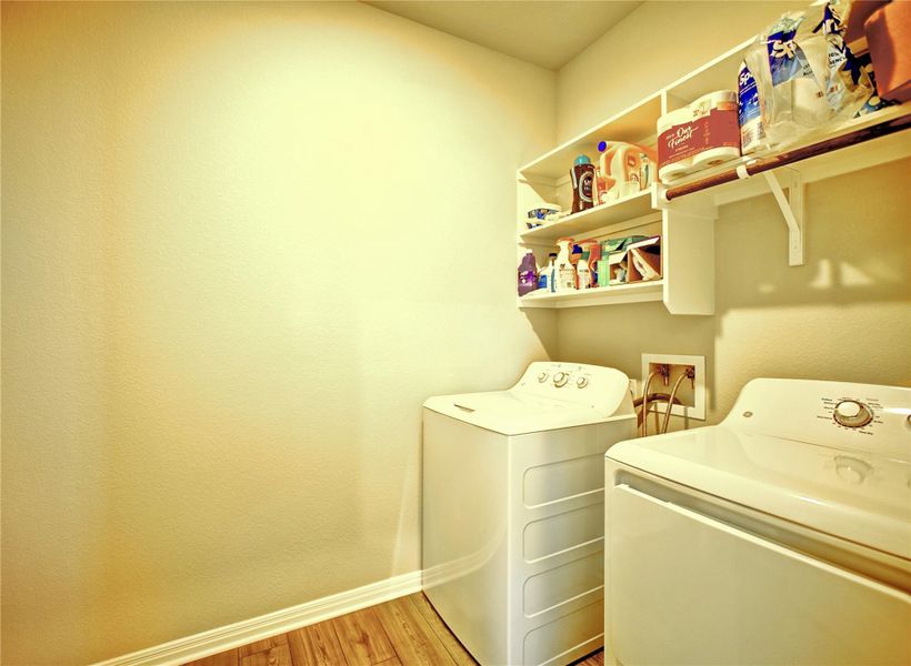 Laundry room featuring light wood-type flooring and independent washer and dryer Laundry room featuring light wood-type flooring and independent washer and dryer