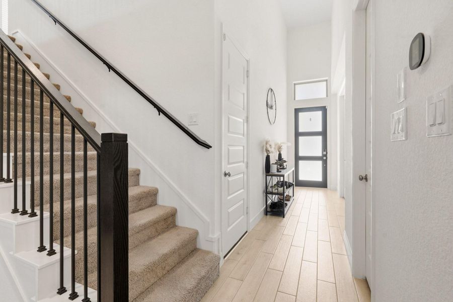 Elegant staircase and entry hall showcasing the home's open and airy design