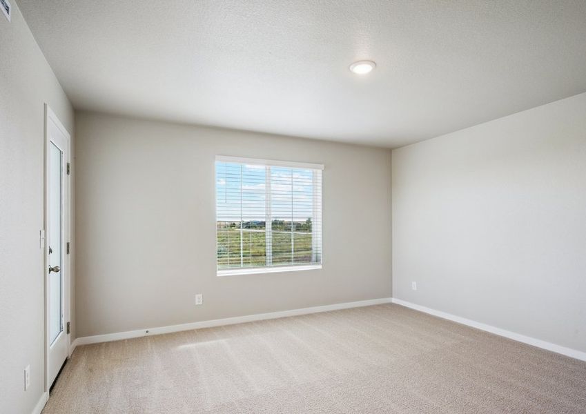 The master bedroom has a large window and carpet.