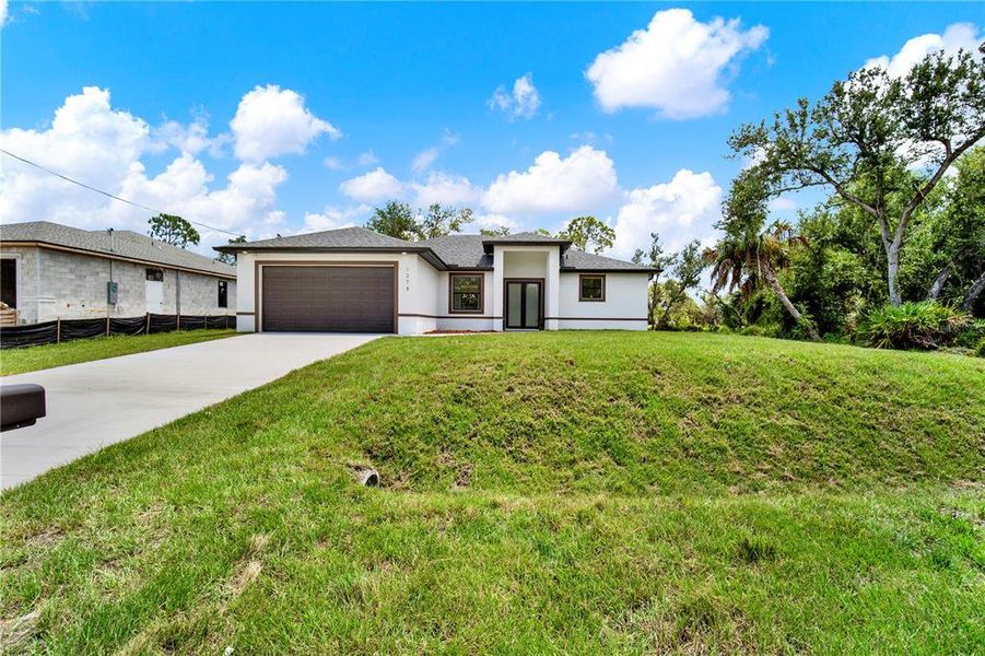 Front exterior of a new home in , Port Charlotte, FL, highlighting curb appeal (Image 26).