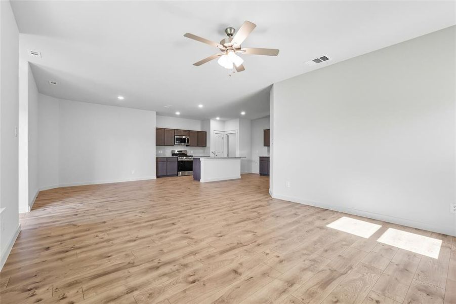 Unfurnished living room featuring light wood-style flooring, recessed lighting, and ceiling fan