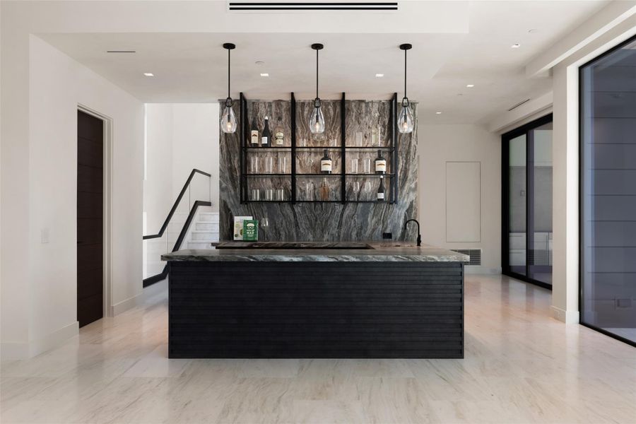 Bar featuring open shelves, dark wood finish cabinets, pendant lighting, and stone counters