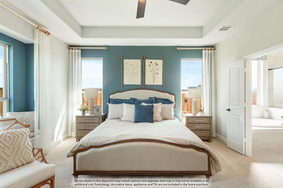 Master bedroom with tray ceiling, teal accent wall, ceiling fan, and ensuite bathroom access Master bedroom with tray ceiling, teal accent wall, ceiling fan, and ensuite bathroom access