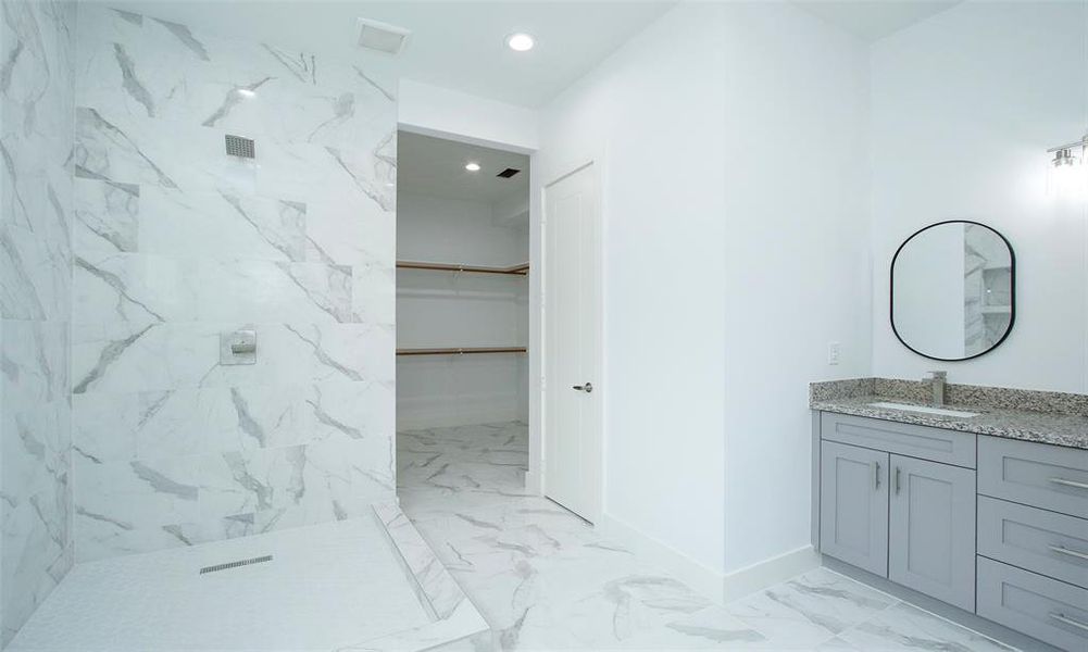 Primary bathroom has a clean, minimalist aesthetic with a neutral color palette.