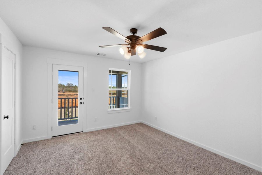 This charming second-floor guest suite features its own private farmhouse-style balcony, creating a welcoming retreat your guests will love.
