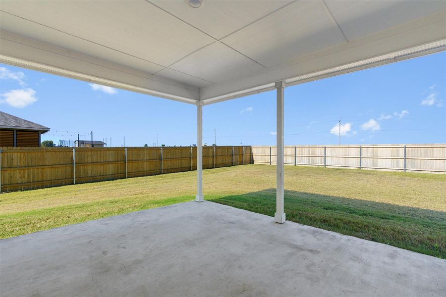 Fenced backyard with a patio area