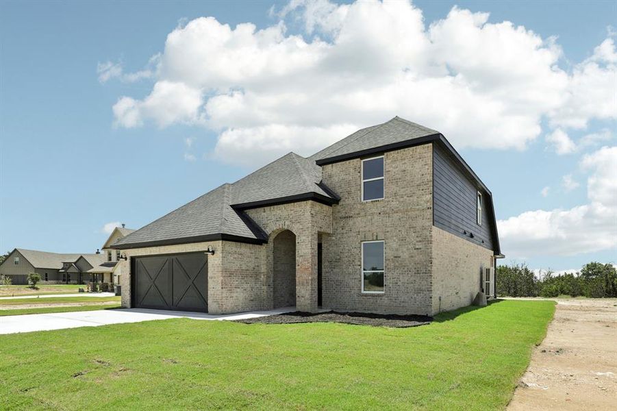 View of front of property with a garage and a front yard