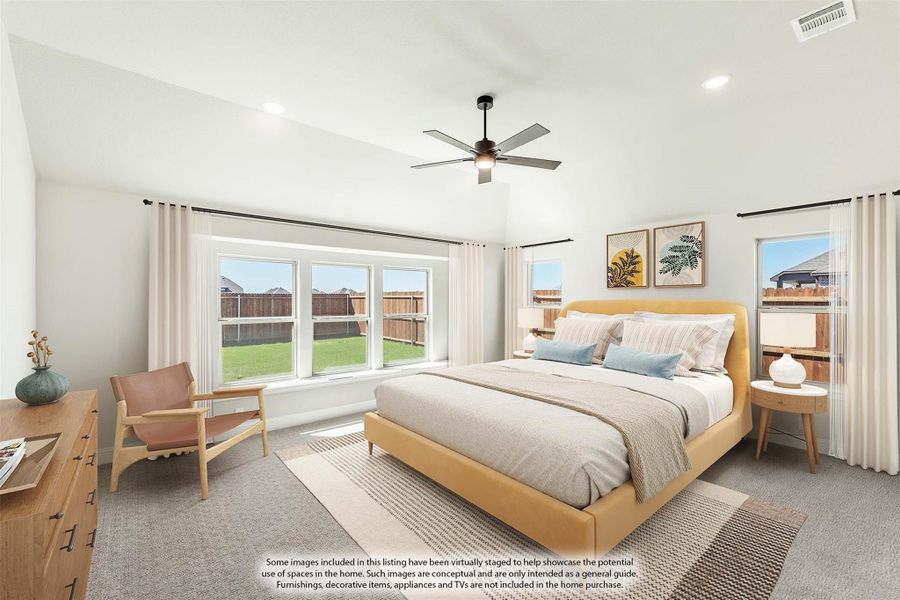 Spacious master bedroom with yellow upholstered bed, ceiling fan, and large windows overlooking backyard Spacious master bedroom with yellow upholstered bed, ceiling fan, and large windows overlooking backyard