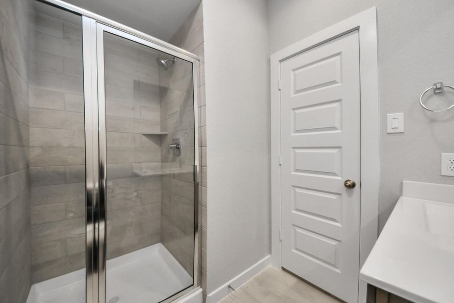 Experience sophistication in the guest suite bathroom, where tile flooringcomplements a walk-in shower with tile surround. Light wood cabinets completewith a beautiful light countertop, enhances the space for a truly invitingambiance. Sample photo of completed home with similar floor plan. Actual colors and selections may vary. Experience sophistication in the guest suite bathroom, where tile flooringcomplements a walk-in shower with tile surround. Light wood cabinets completewith a beautiful light countertop, enhances the space for a truly invitingambiance. Sample photo of completed home with similar floor plan. Actual colors and selections may vary.