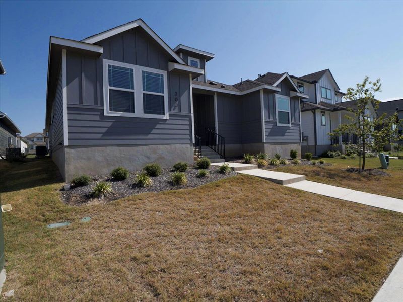 View of front of home featuring board and batten siding and a front lawn View of front of home featuring board and batten siding and a front lawn