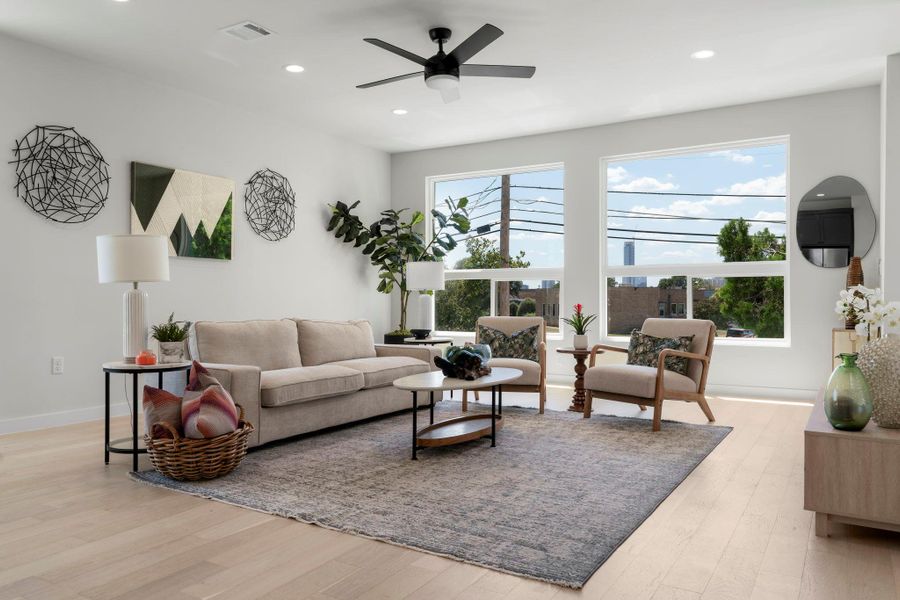 Living room with recessed lighting, light wood-type flooring, and a ceiling fan