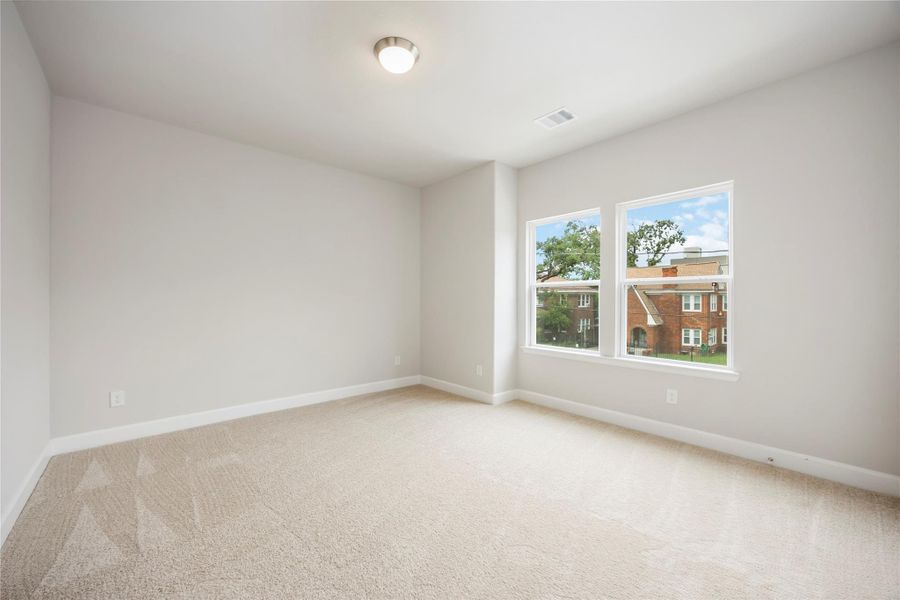 Discover custom shelving in the closet of this second-floor bedroom, sharing a hall bathroom, where practicality meets personalized storage solutions.