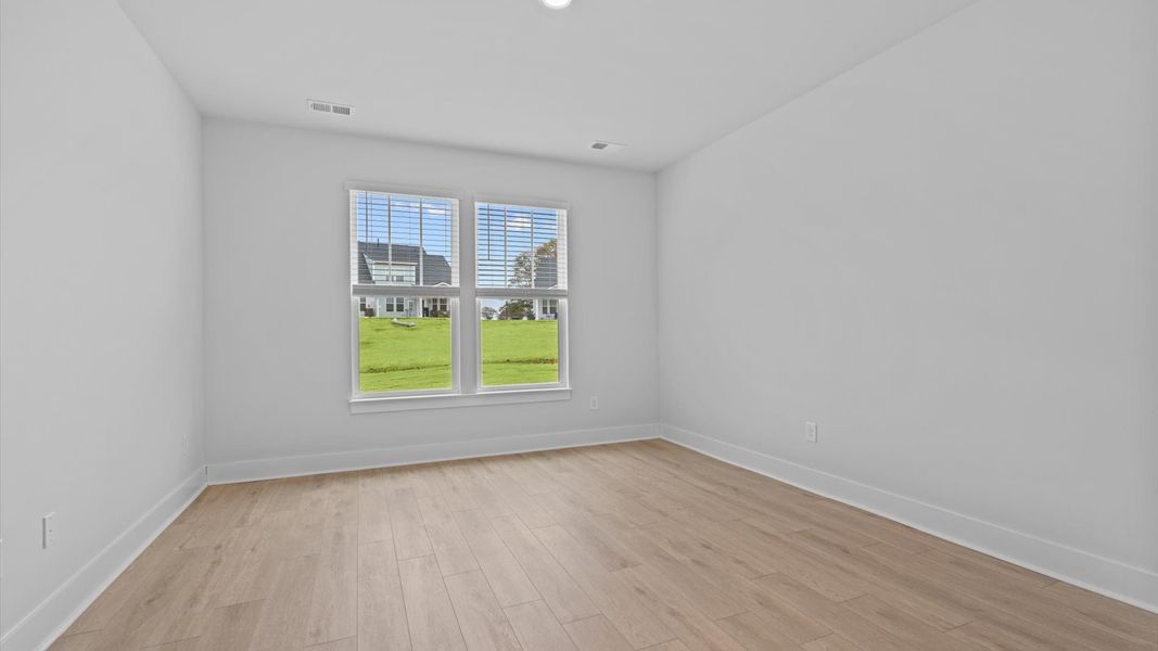 Vibrant natural light fills this exceptional primary suite with eye-catching details